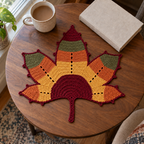Harvest Mosaic leaf mat with wine red, ochre, burnt orange and olive stripes and an eyelet texture.