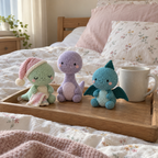 A mint sleepy dinosaur with a pink nightcap and striped blanket beside a lilac Brachiosaurus and teal Pterodactyl on a bed tray.