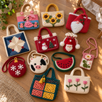 Twelve crochet bags from different collections arranged on a wooden floor, including totes, round crossbody bags, a watermelon bag, a Santa pouch and a Lotus phone bag.