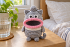 Grey Cat crochet key pouch with pointed ears, a white band, white whiskers and a pink rolled lip around an open, empty mouth.