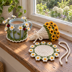 A daisy Flower Garden coaster hugs a pale-blue mug beside an open flat daisy Flower Bouquet coaster and a tied sunflower bouquet on a sunny wooden windowsill.
