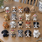 Twenty different small crochet dog keychains with rings and clasps seated together on a wooden dining table.