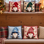 Four square gnome pillow covers with heart, holly, snowflake and candy details displayed on cushioned seats.