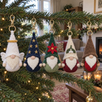 Angel, Starry Night, Poinsettia, Mistletoe and Robin gnome keychains hanging from a Christmas tree branch.