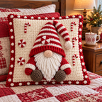 Candy Gnome crochet pillow with a red-and-white striped hat, peppermints, four candy canes and white bobbles on a red-and-white quilt beside a mug of cocoa.