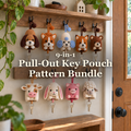 Nine animal crochet key pouches hanging from hooks by a front door with keys attached: 9-in-1 Pull-Out Key Pouch Pattern Bundle