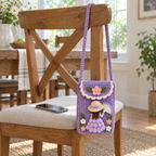 Lavender crochet Fan Lady phone bag hangs from a wooden chair by its crochet strap, with a smartphone on the seat.