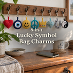 Eight crochet symbol keyring charms hanging from a wooden entryway hook rail above a dresser: heart, evil eye, smiley, peace sign, crown, gem, horseshoe and yin-yang, with the title 8-in-1 Lucky Symbol Bag Charms.