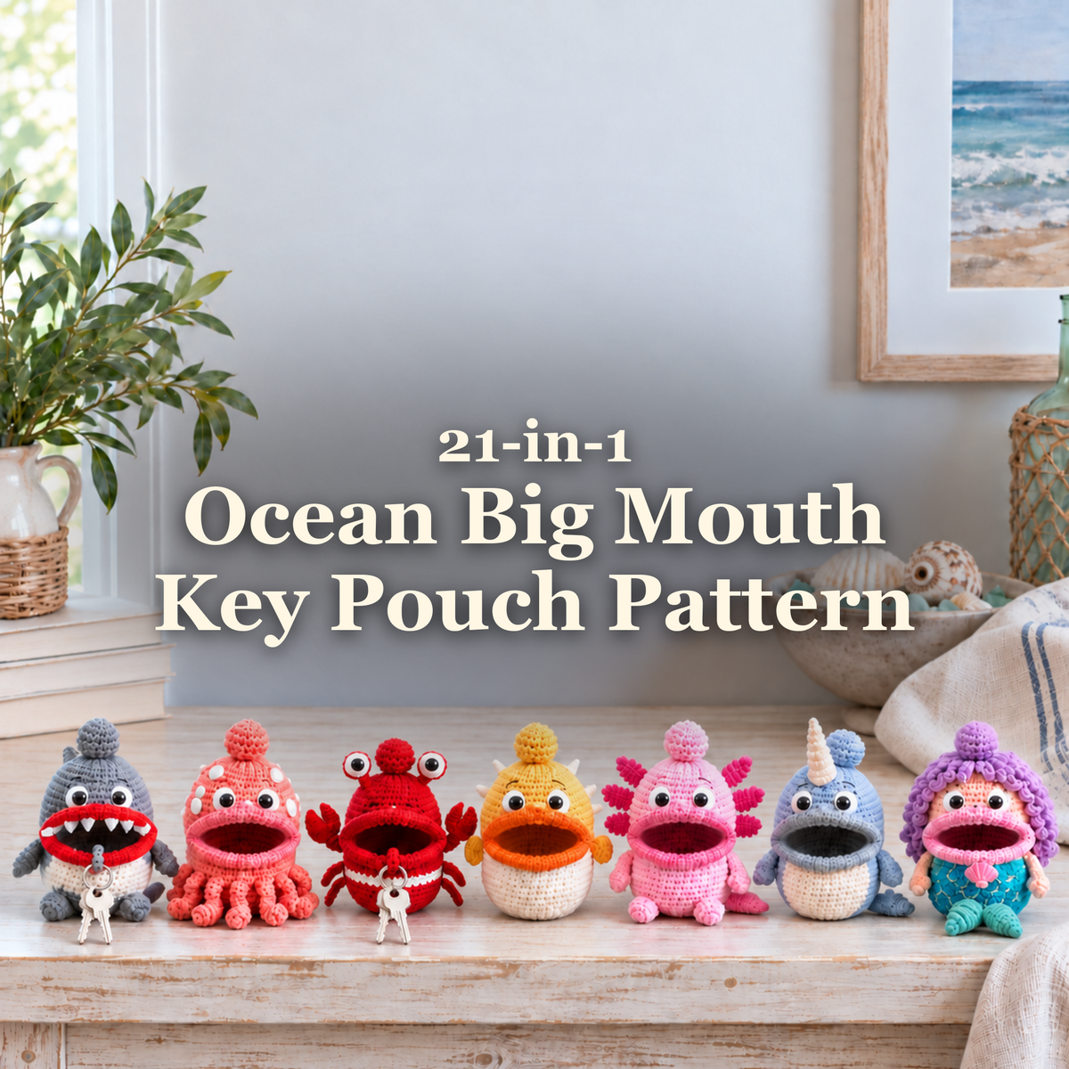 Seven ocean-themed crochet key pouches beneath the title 21-in-1 Ocean Big Mouth Key Pouch Pattern on a coastal console.