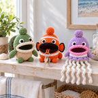 Sea Turtle, Clownfish and Jellyfish crochet key pouches on a sunny bathroom shelf, with two keys outside Clownfish and six white Jellyfish tentacles over the shelf edge.