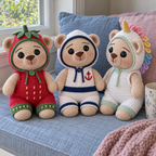 Strawberry, sailor and unicorn crochet teddy bears sit on a cushioned window seat.