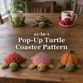 Six crocheted turtle coasters on a wooden table, with the title 21-in-1 Pop-Up Turtle Coaster Pattern.