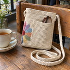 Reading glasses tucked into a cream back pocket beside a cup of tea, with Dresden Plate colours visible at the turned corner.