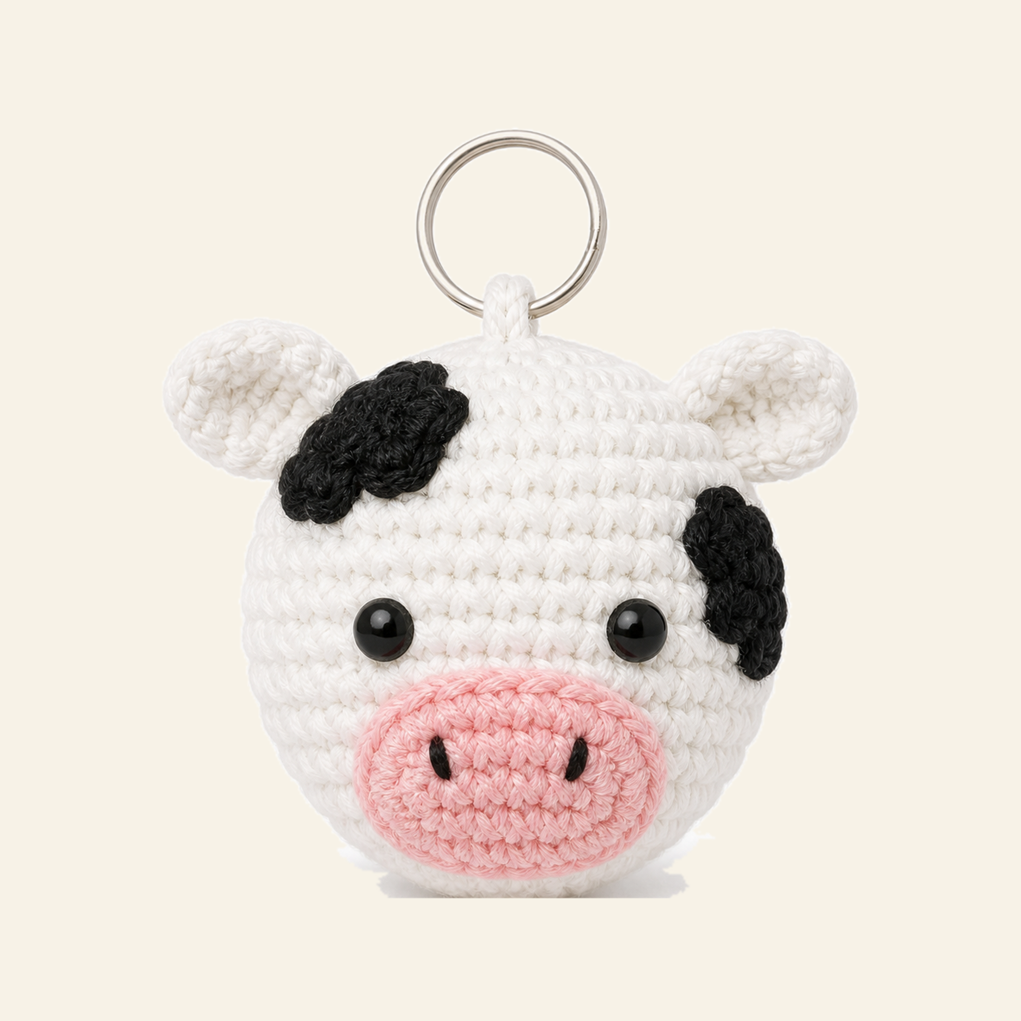 The finished crochet Cow bag charm on its own