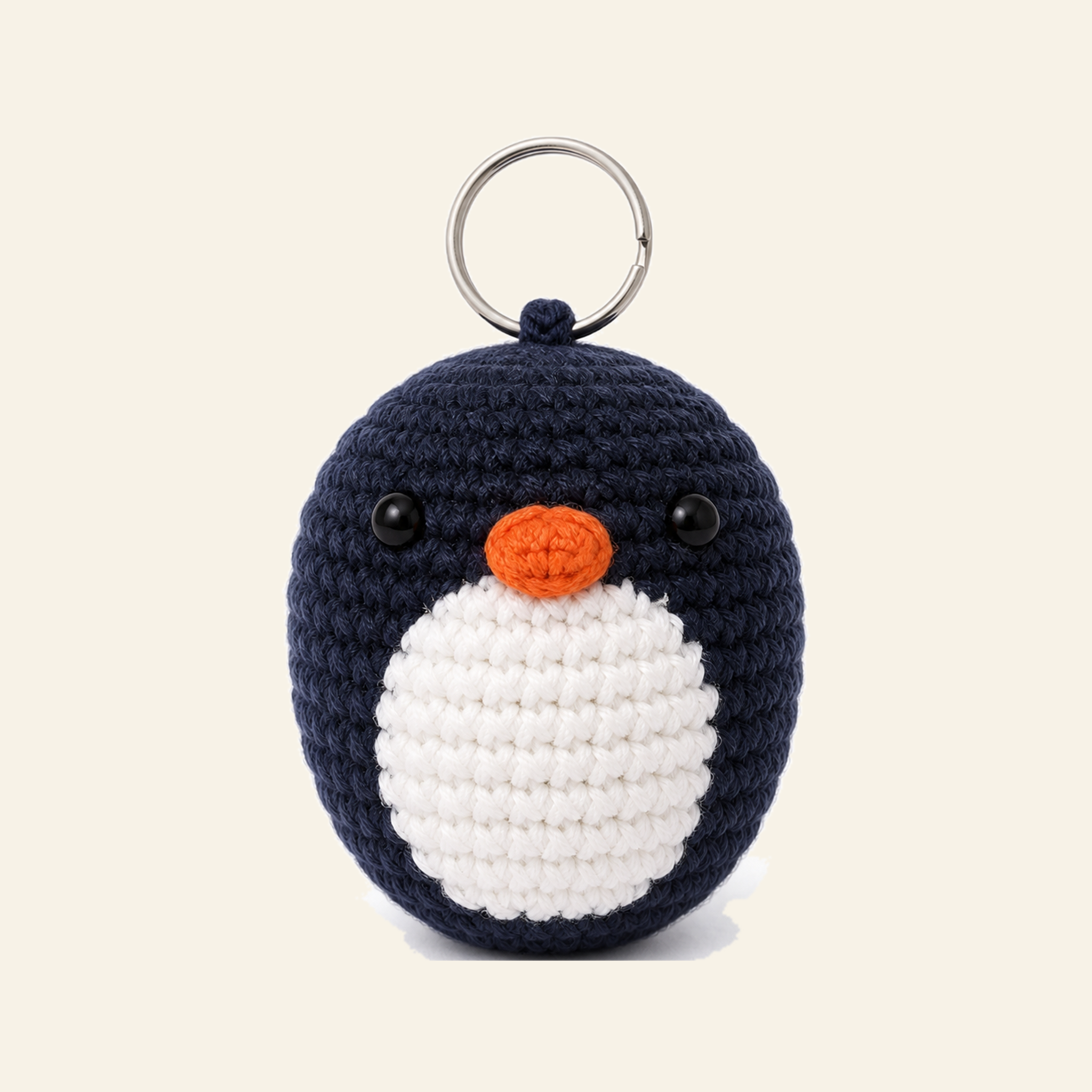 The finished crochet Penguin bag charm on its own