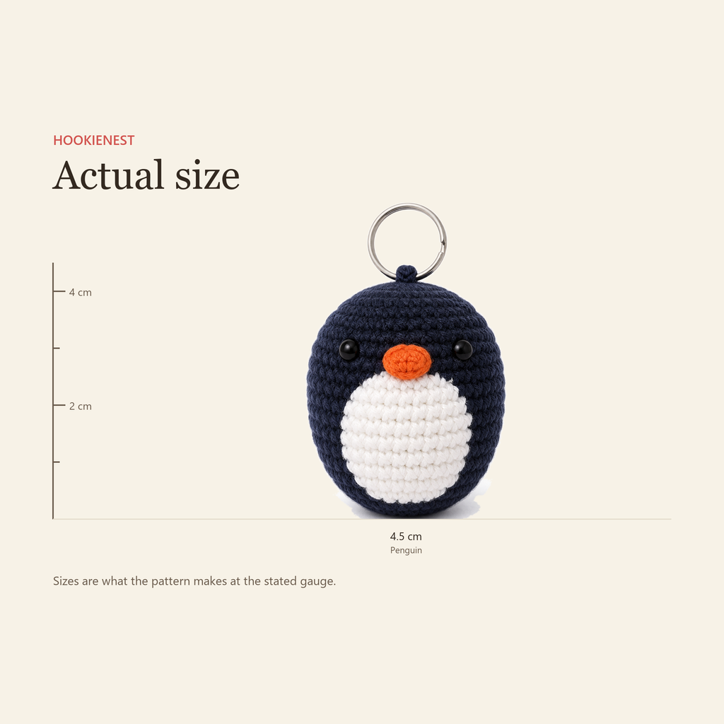 The Penguin charm beside a centimetre ruler, finishing at 4.5 cm