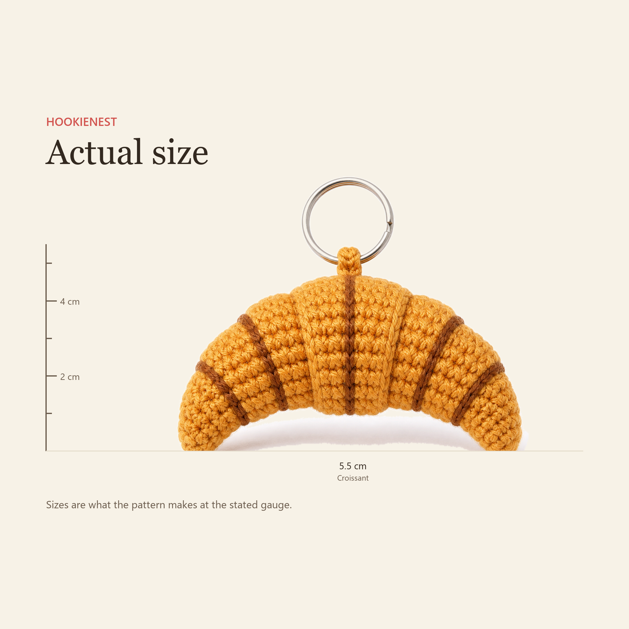 The Croissant charm beside a centimetre ruler, finishing at 5.5 cm