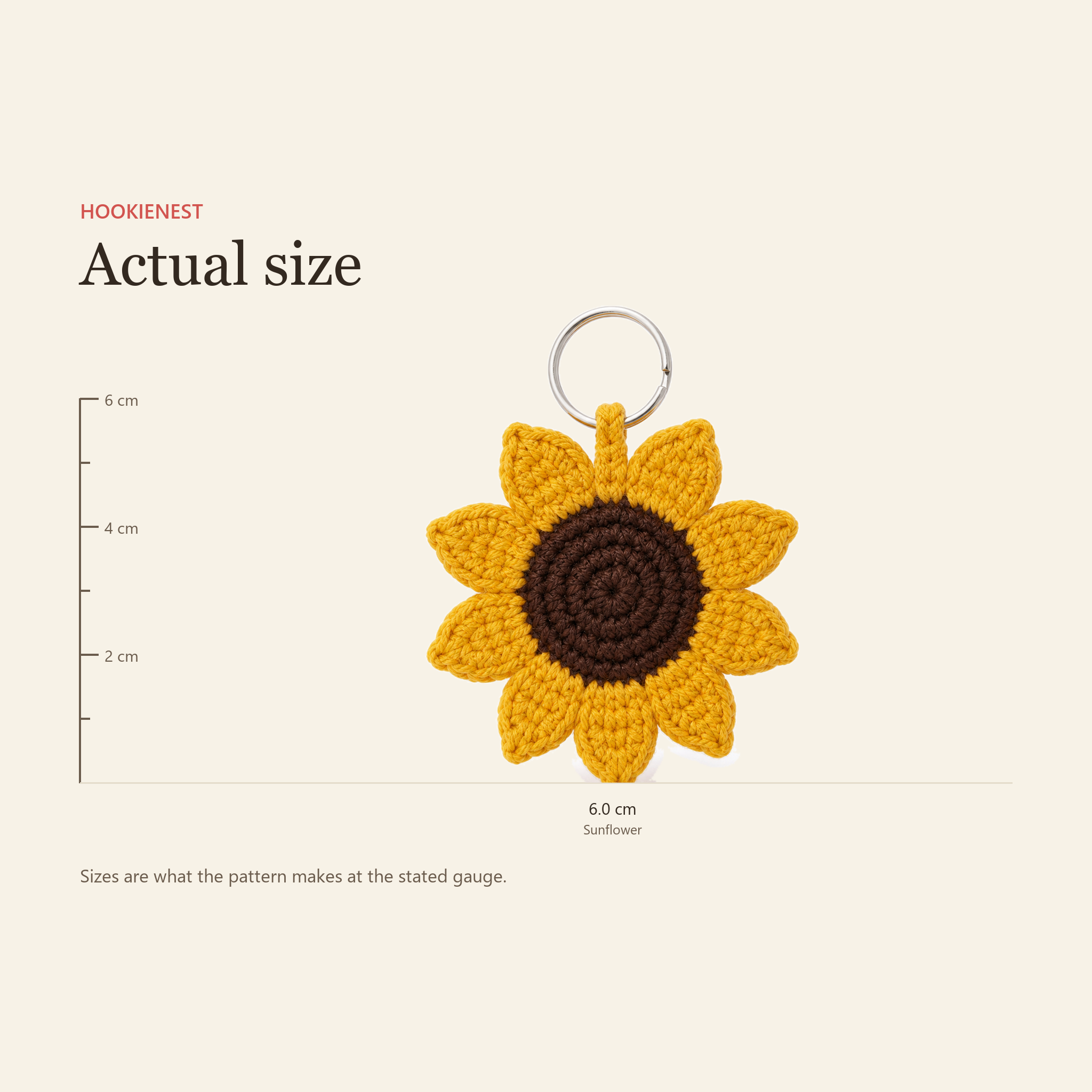 The Sunflower keychain beside a centimetre ruler, finishing at 6.0 cm