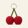 The finished crochet Cherry Pair bag charm on its own