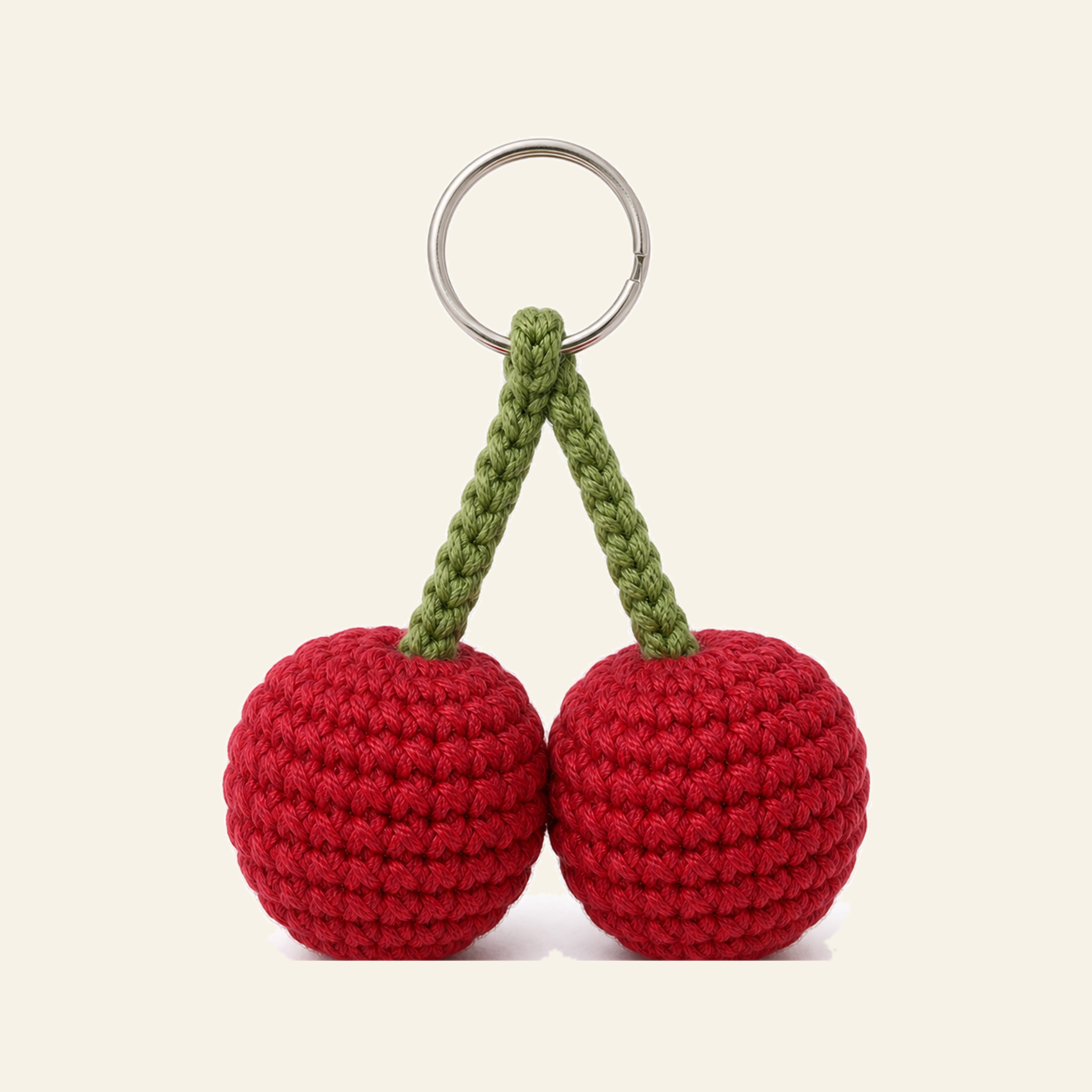The finished crochet Cherry Pair bag charm on its own