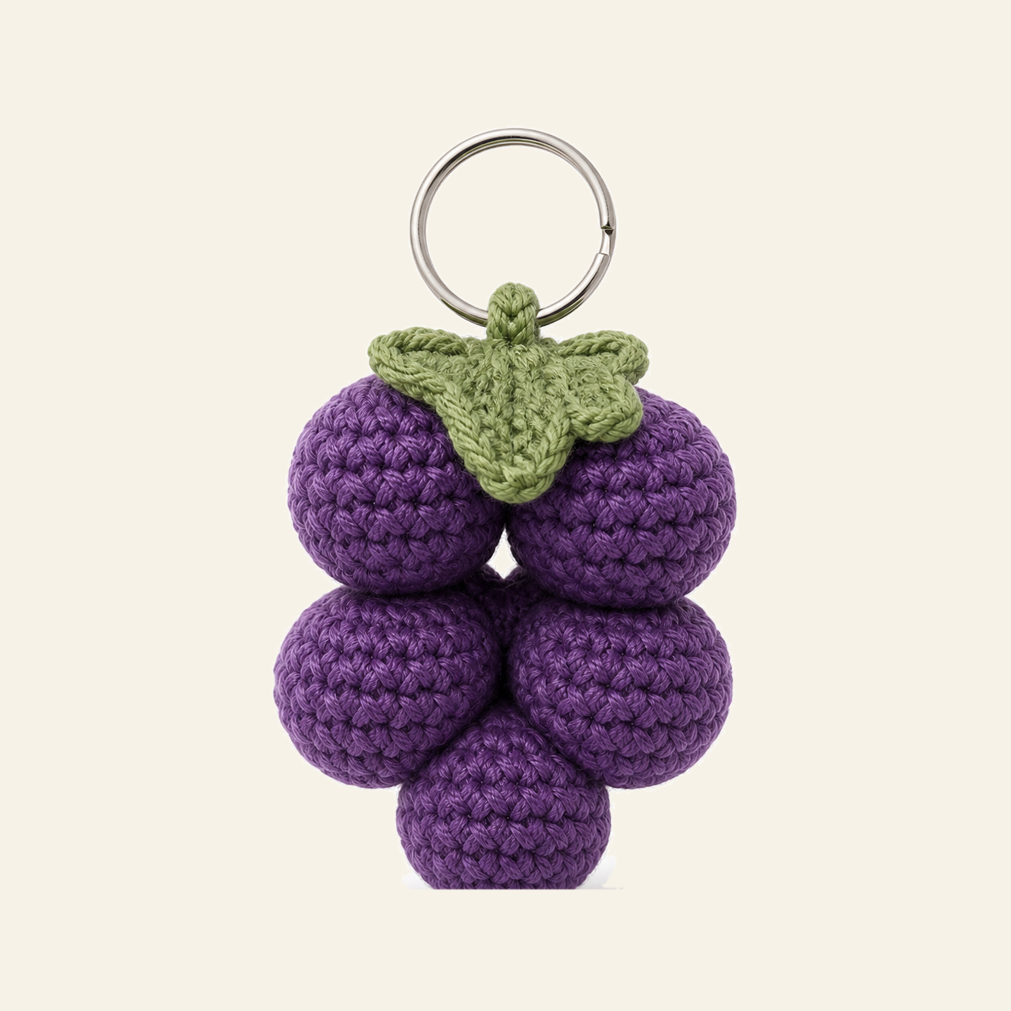 The finished crochet Grape Cluster bag charm on its own