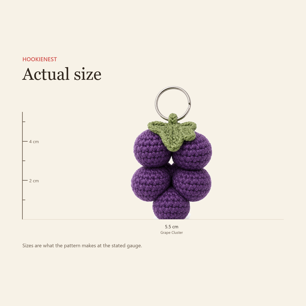 The Grape Cluster charm beside a centimetre ruler, finishing at 5.5 cm
