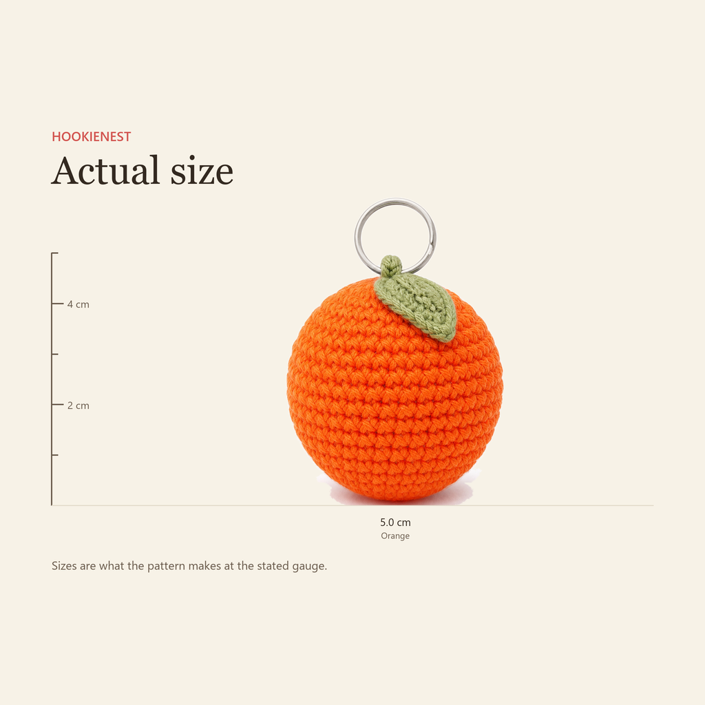 The Orange charm beside a centimetre ruler, finishing at 5.0 cm