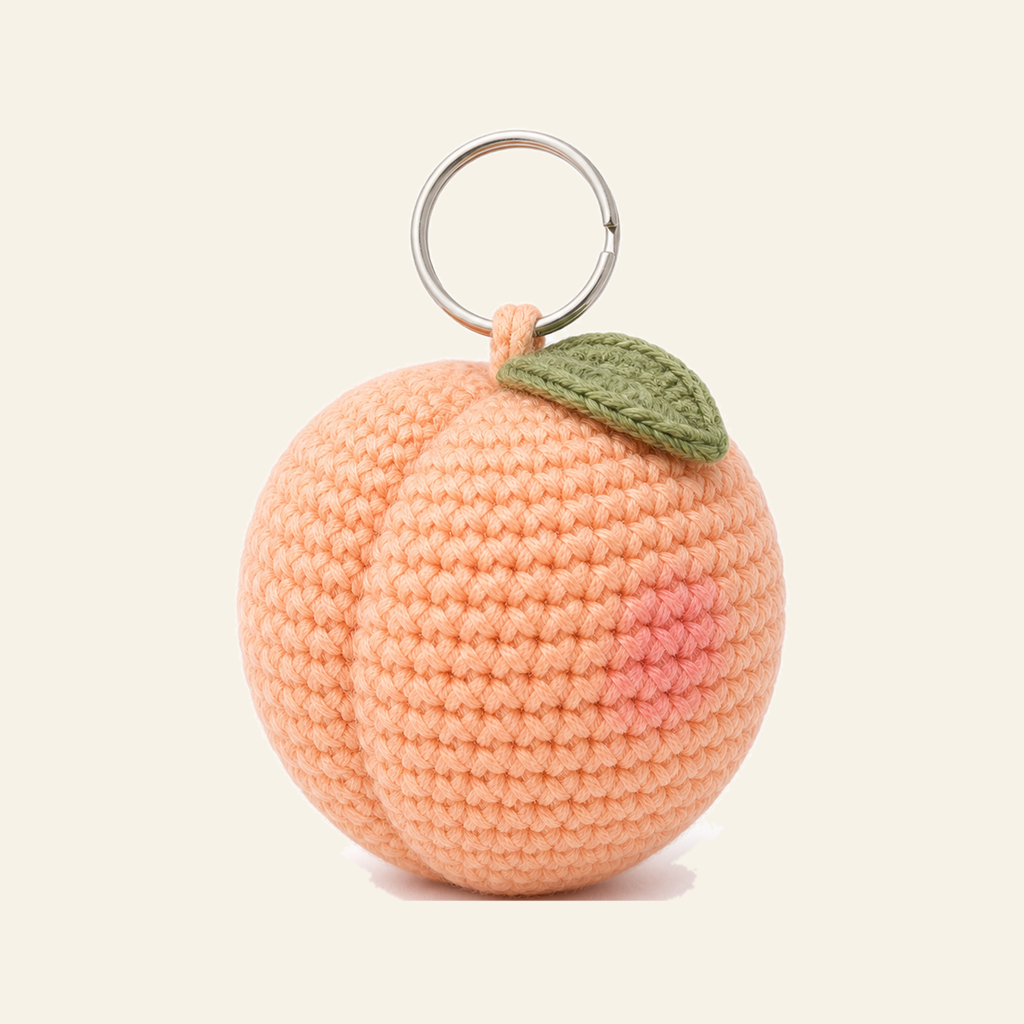 The finished crochet Peach bag charm on its own