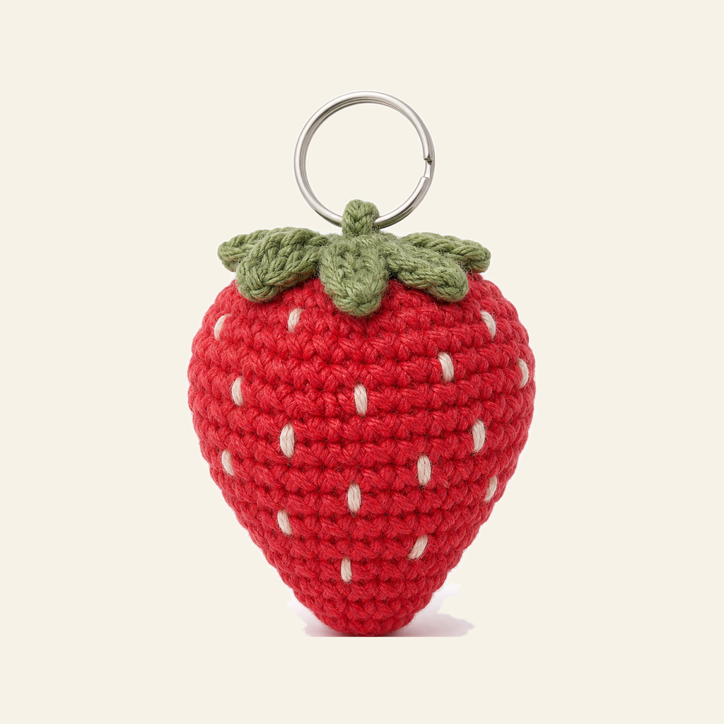 The finished crochet Strawberry bag charm on its own