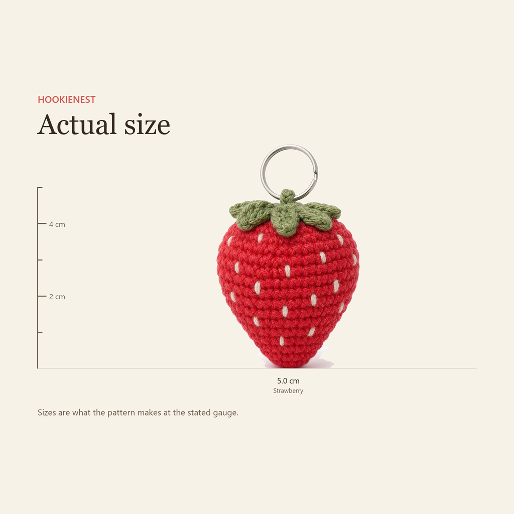 The Strawberry charm beside a centimetre ruler, finishing at 5.0 cm