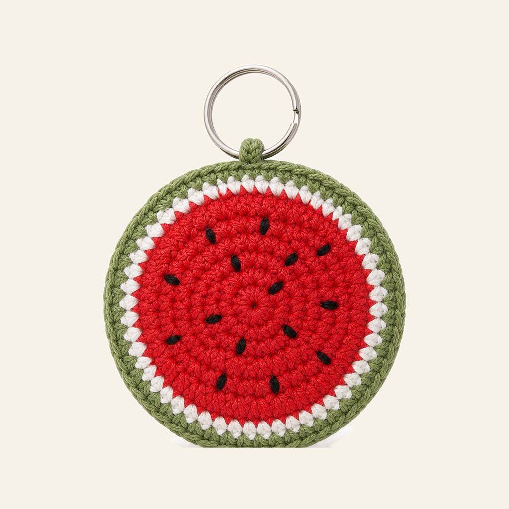 The finished crochet Watermelon Slice bag charm on its own
