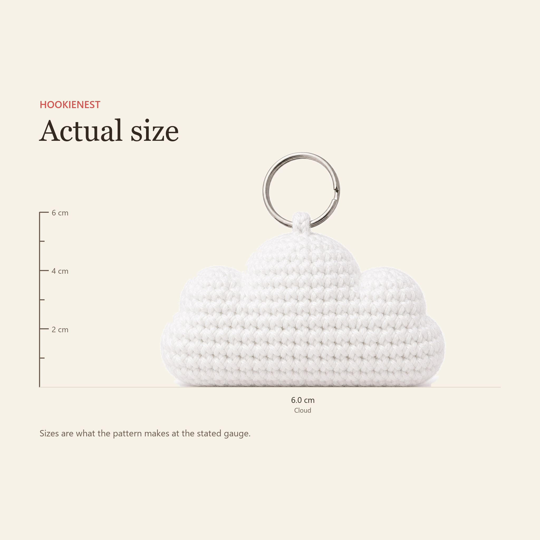 The Cloud charm beside a centimetre ruler, finishing at 6.0 cm
