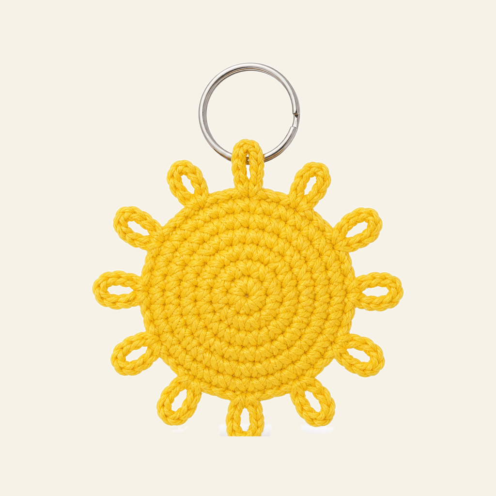 The finished crochet Sun bag charm on its own