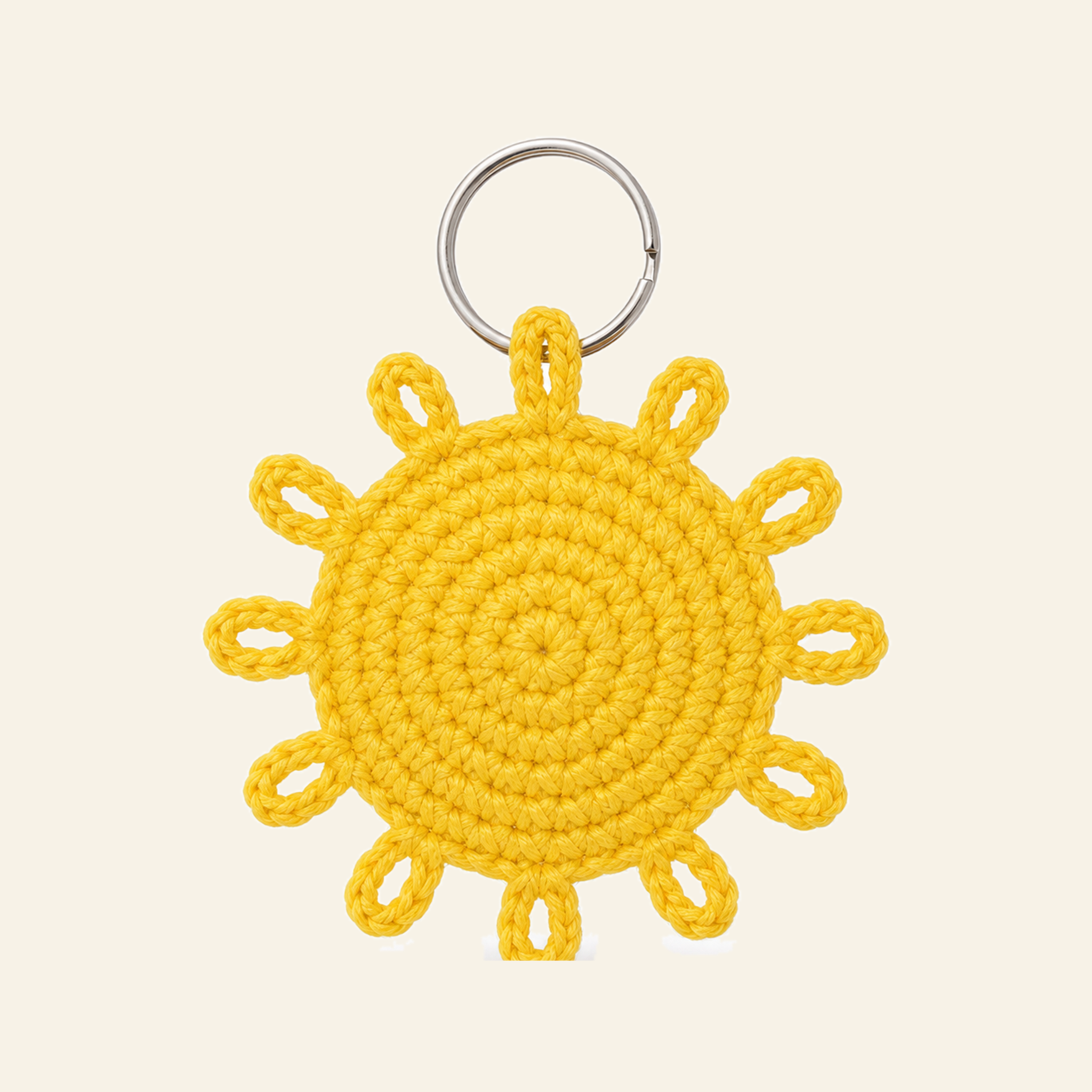 The finished crochet Sun bag charm on its own