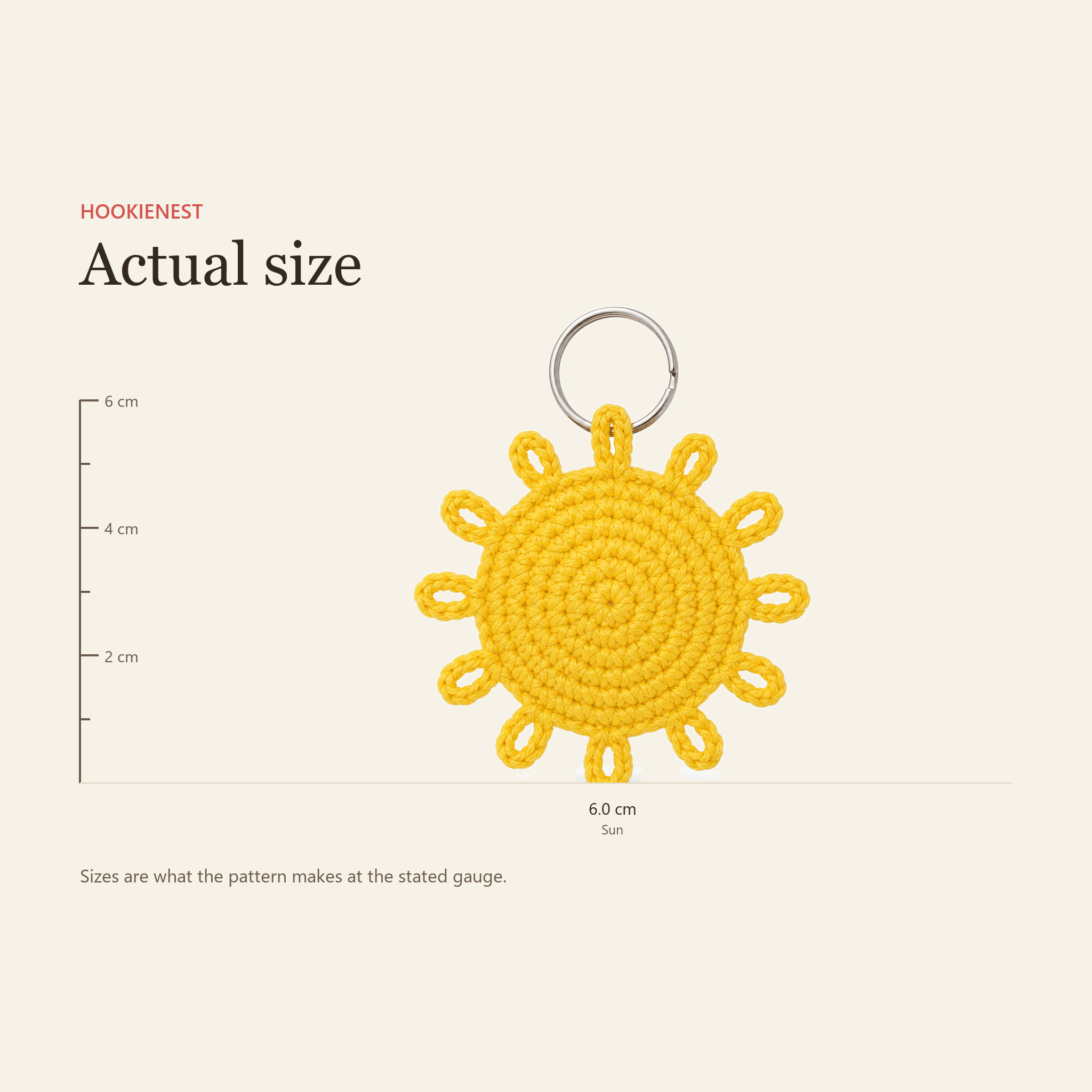 The Sun charm beside a centimetre ruler, finishing at 6.0 cm
