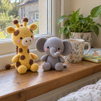 A yellow crochet Giraffe sitting taller than a grey Elephant on a sunny windowsill beside a plant and mug.