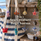 Eight miniature crochet sea creatures hanging beside a striped beach tote in a sunny coastal home, with the title 8-in-1 Sea Creature Bag Charms.