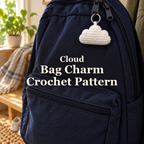 White crocheted cloud bag charm hanging from a navy backpack zipper in a sunlit home entryway, with the title Cloud Bag Charm Crochet Pattern.