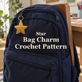A yellow crochet star charm hangs from the upper zipper of a navy school backpack on a wooden chair, with the title Star Bag Charm Crochet Pattern.