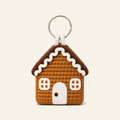 Crochet gingerbread house ornament with white icing, a door and two windows