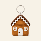 Crochet gingerbread house ornament with white icing, a door and two windows