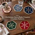 Five hexagonal Christmas snowflake crochet coasters in ivory, blue-grey, navy, green and ruby red on a wooden table, with coffee, a water glass and the product title.