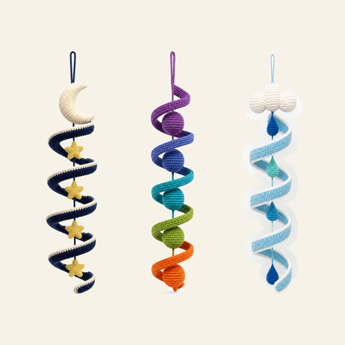 Three crochet wind spinners in a row - rainbow, rain cloud and night sky
