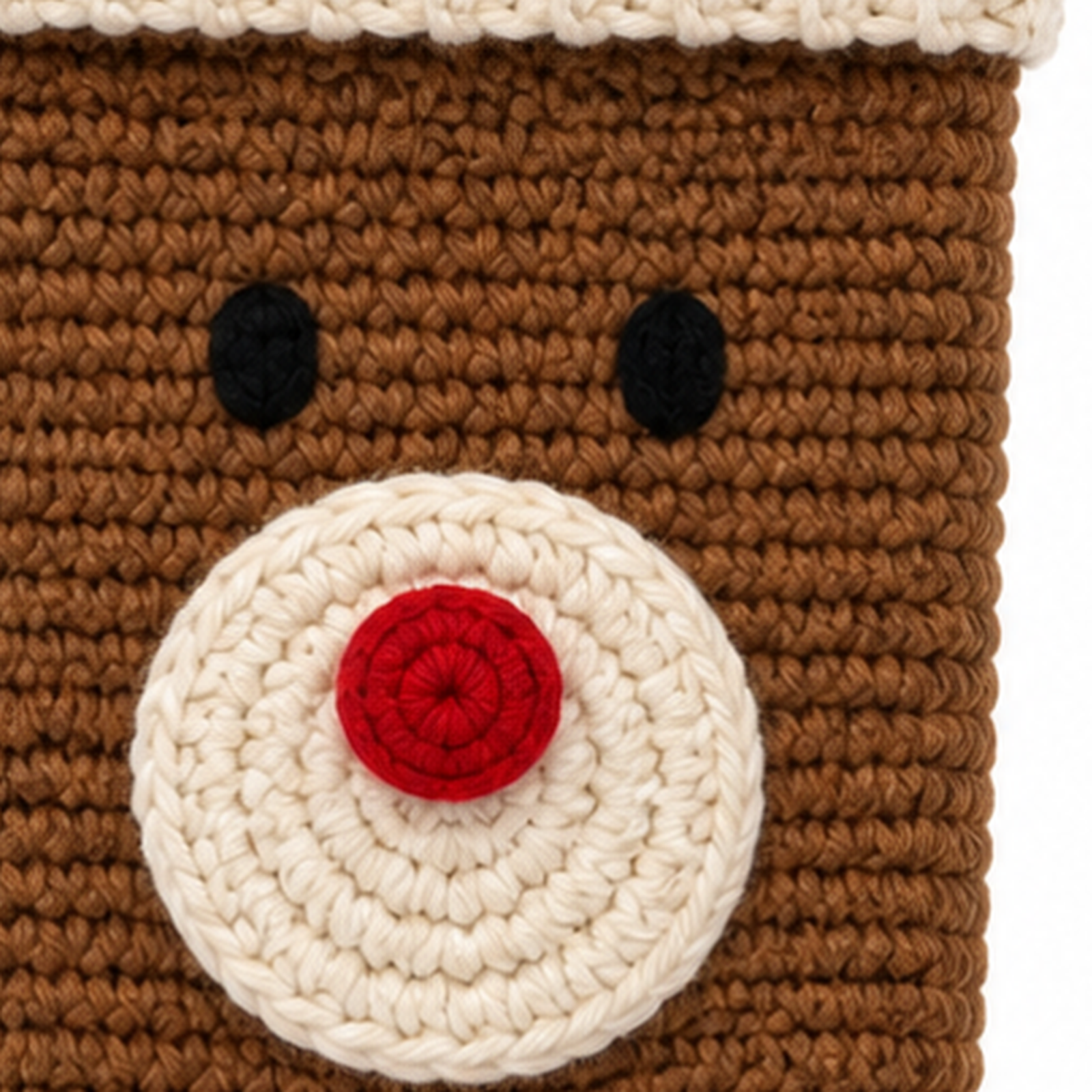 Close-up of the single crochet stitch texture and applique on a crochet Christmas stocking