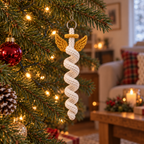 An ivory spiral crochet Angel with gold wings and a gold halo hanging from a pine branch beside warm Christmas lights.