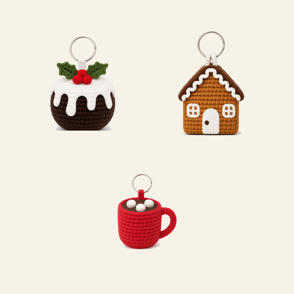 Three crochet Christmas treat ornaments: a hot cocoa mug, a gingerbread house and a Christmas pudding